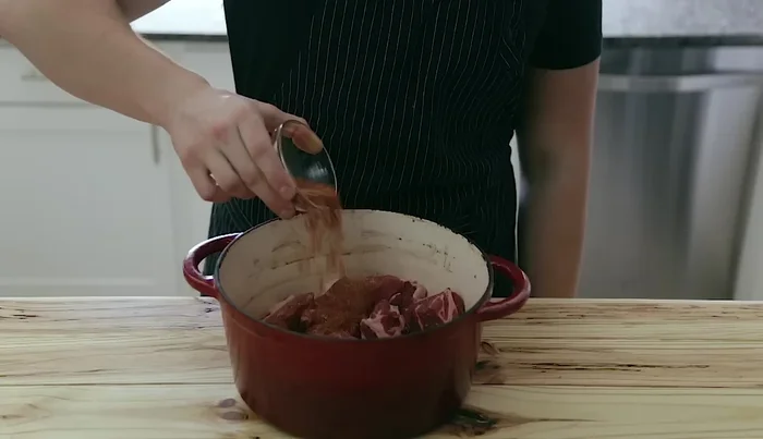 Place the pork in a cold large Dutch oven. Add the spice mixture, garlic, and toss to coat.