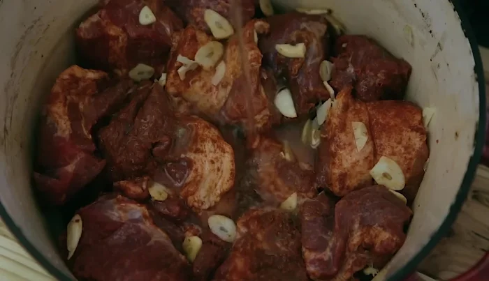 Add lime juice and enough water to mostly cover the pork.