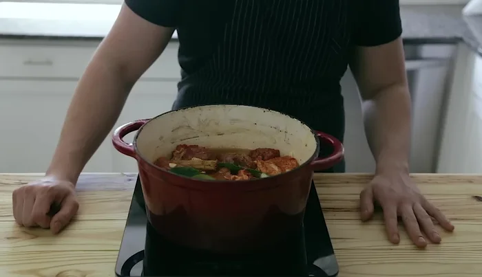 Bring to a simmer on the stovetop, then transfer to a preheated oven (with lid off) at 350°F (175°C) for 3-4 hours, or until the meat is tender.