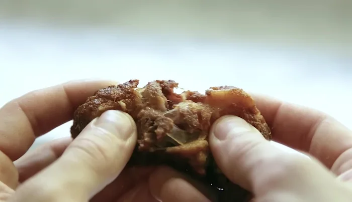 Return the carnitas to the oven at 400°F (200°C) for 10 minutes to crisp.