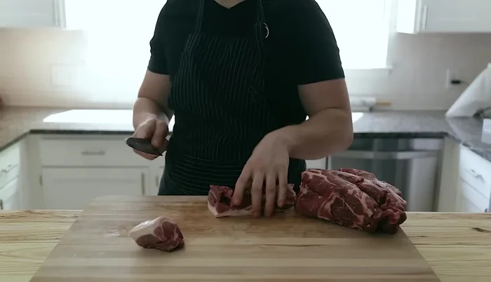 Cut the pork shoulder into 2-inch chunks. Leave the fat on.