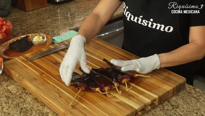 Prepare the guajillo chiles: remove stems and devein.