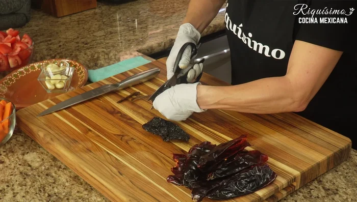 Prepare the pasilla chiles: remove stems and devein.