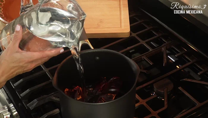 Boil the guajillo and pasilla chiles with 6 cloves of garlic until soft.