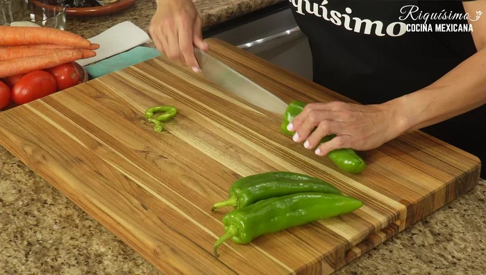 Prepare the Anaheim chiles: remove stems, devein, and cut into thin strips.