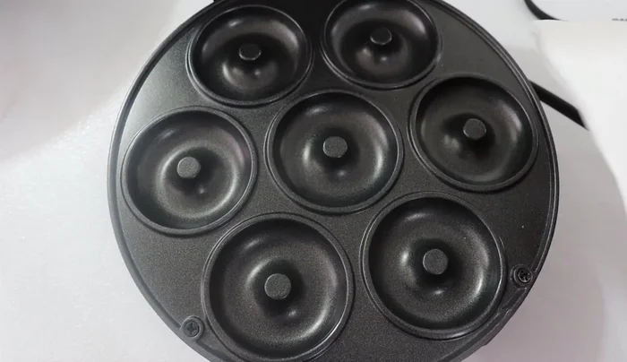 Prepare the donut machine: Lightly grease the donut machine with cooking oil or nonstick spray.