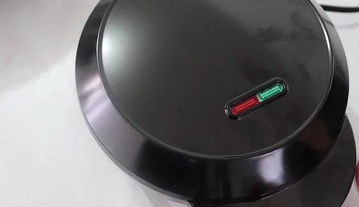 Preheat the donut machine: Turn on the machine and wait until the indicator light changes from red to green, indicating it's ready.