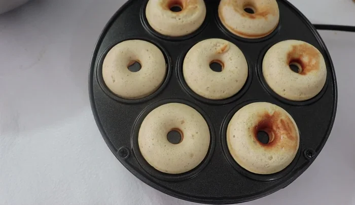 Remove and cool: Once cooked, carefully remove the mini donuts from the machine and let them cool completely.