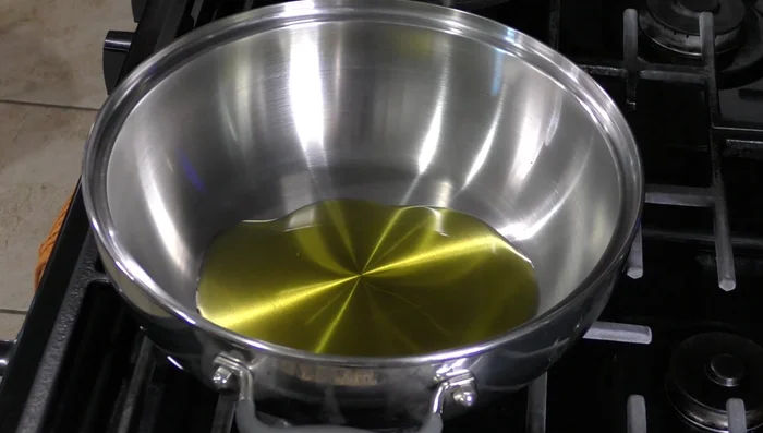 Heat olive oil in a pan. Add sliced onion and fry until browned.