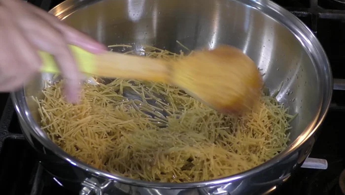 Add noodles to the pan and fry until browned, stirring constantly.