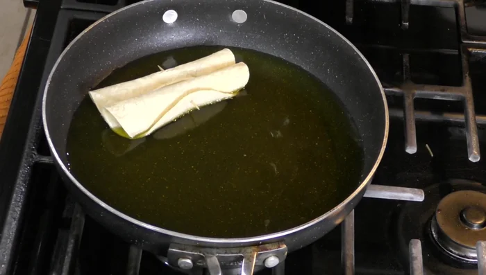 Fry the tacos in hot oil until golden brown.
