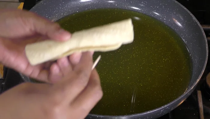 Brown the assembled tacos in hot oil until golden brown.