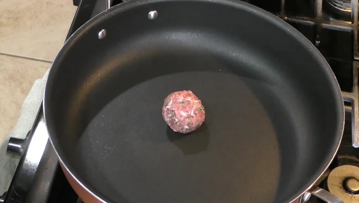 Lightly fry the meatballs in a pan without adding oil, until browned on both sides. They will cook in their own fat.