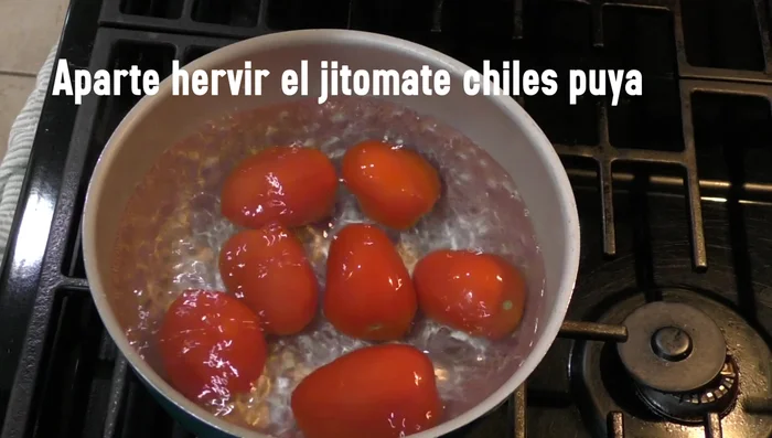 Add tomatoes and pua chiles to the boiling chicken broth. Boil for 6 minutes.