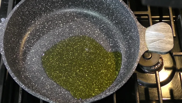 In a frying pan, fry the washed rice in olive oil until golden.