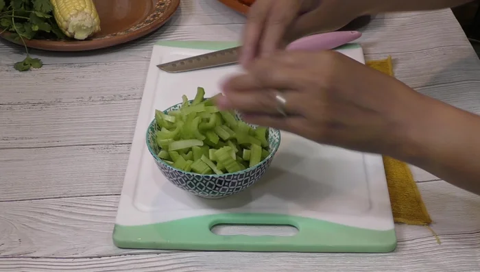Prepare the vegetables: slice the corn, dice the carrots and onions (julienne style for half an onion, chopped for the other half), thinly slice the bell pepper, and chop the celery.