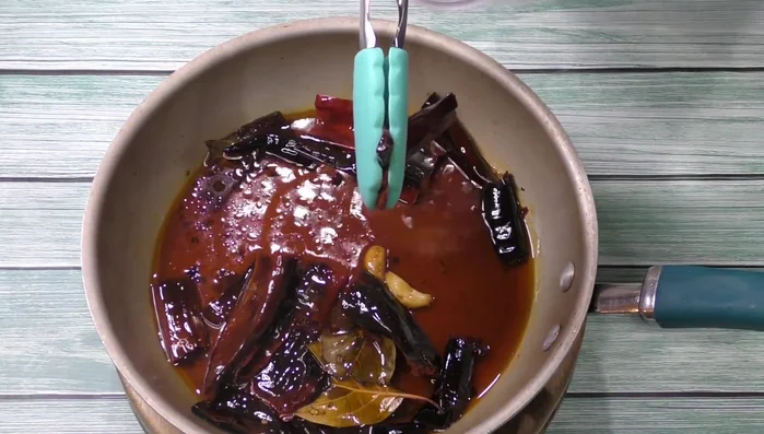 Blend the chilies, garlic, and avocado leaves into a sauce.