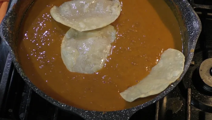 Dip the fried tortillas into the bean mixture.