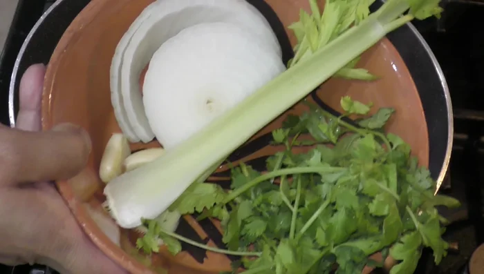 Add onion, celery, garlic, and cilantro to the chicken broth for flavor. Cover and cook until chicken is done (approx. 45 mins).