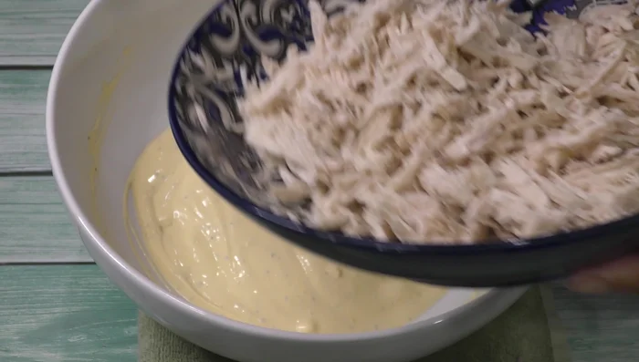 Add shredded chicken to the cream mixture.