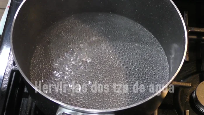 Boil water in a pan, then add the chocolate and cinnamon stick. Let it boil until the chocolate melts completely.