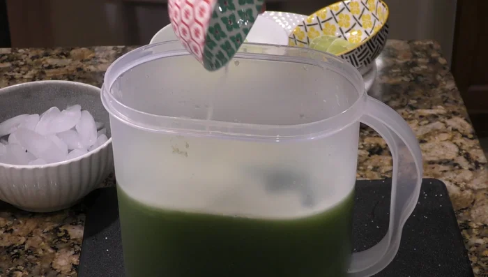 Add the remaining water, lemon juice, and ice to the blended mixture.