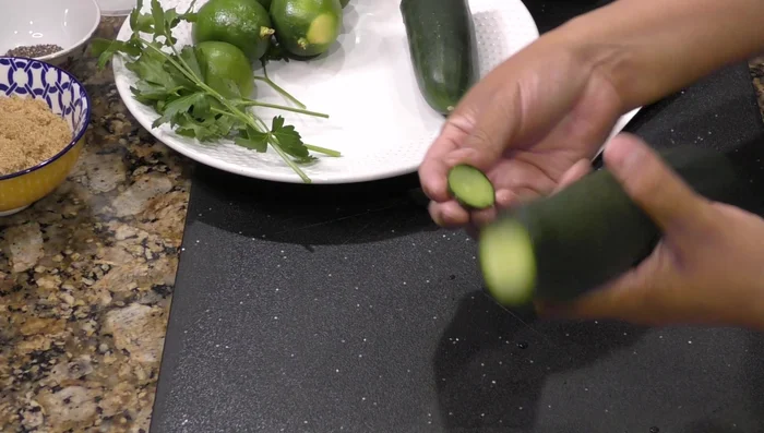 Cut the cucumber into slices. Some believe this removes bitterness.