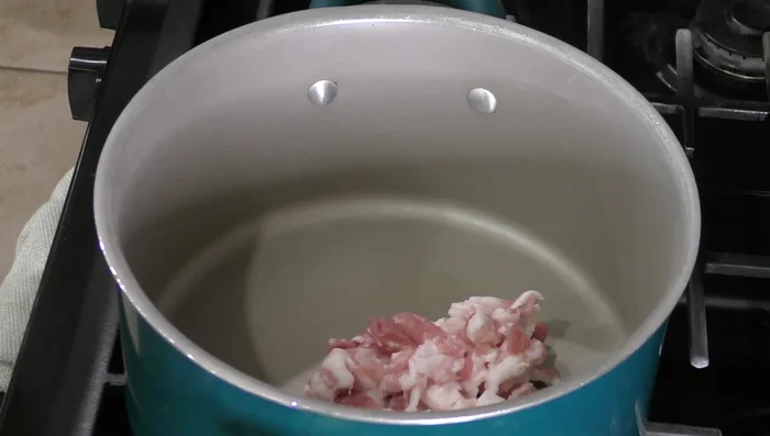 Fry bacon until golden brown, then remove.