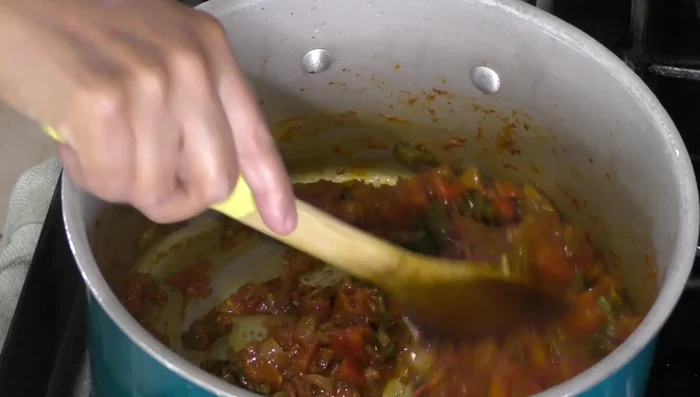 Mix the cooked chorizo, onion, peppers, tomatoes, ham, sausages, and bacon.