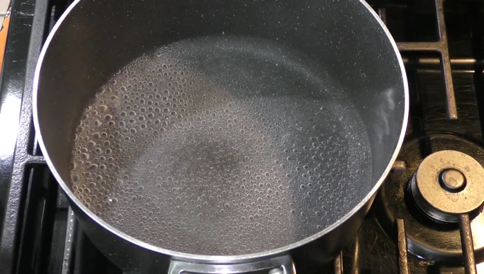 In a pot, add water and bring it to a near boil. Add the piloncillo and cinnamon stick. [40.5]