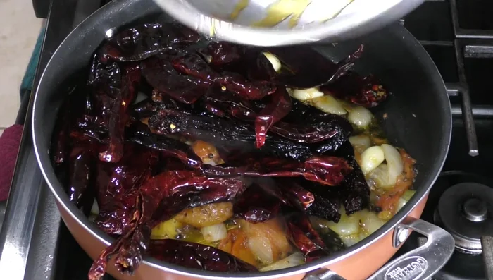 Add the fried chiles to the sautéed vegetables and simmer for 7 minutes.