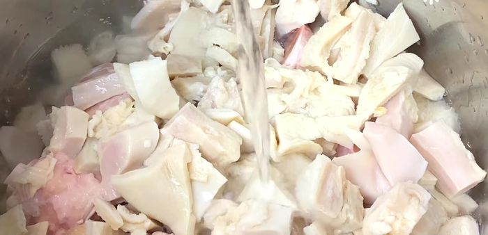 Add enough water to cover all ingredients. Add onion, bay leaves, and Anaheim chili (optional: slit the chili to release flavor). Add onion tails.