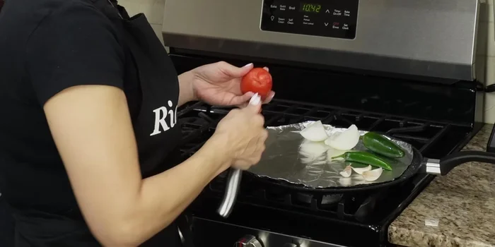 Remove the peduncle (stem) from the tomatoes before roasting for easier blending later.