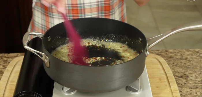 Add chile de árbol and white wine. Cook for about a minute until the alcohol evaporates.