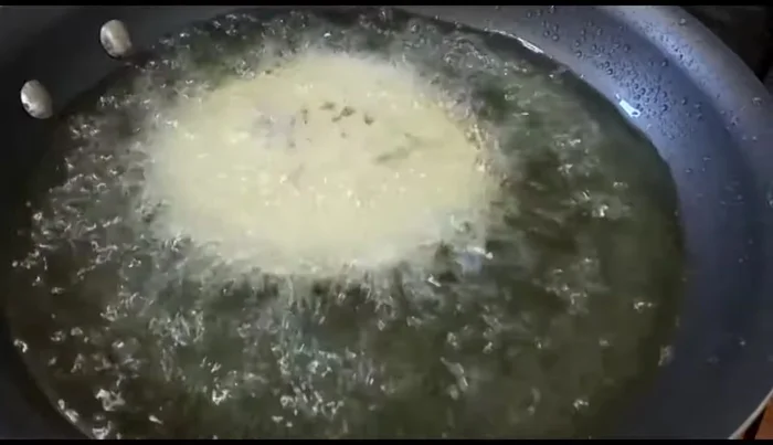 Fry the gorditas: Carefully place the gorditas in the hot oil and fry until golden brown. (380.16)