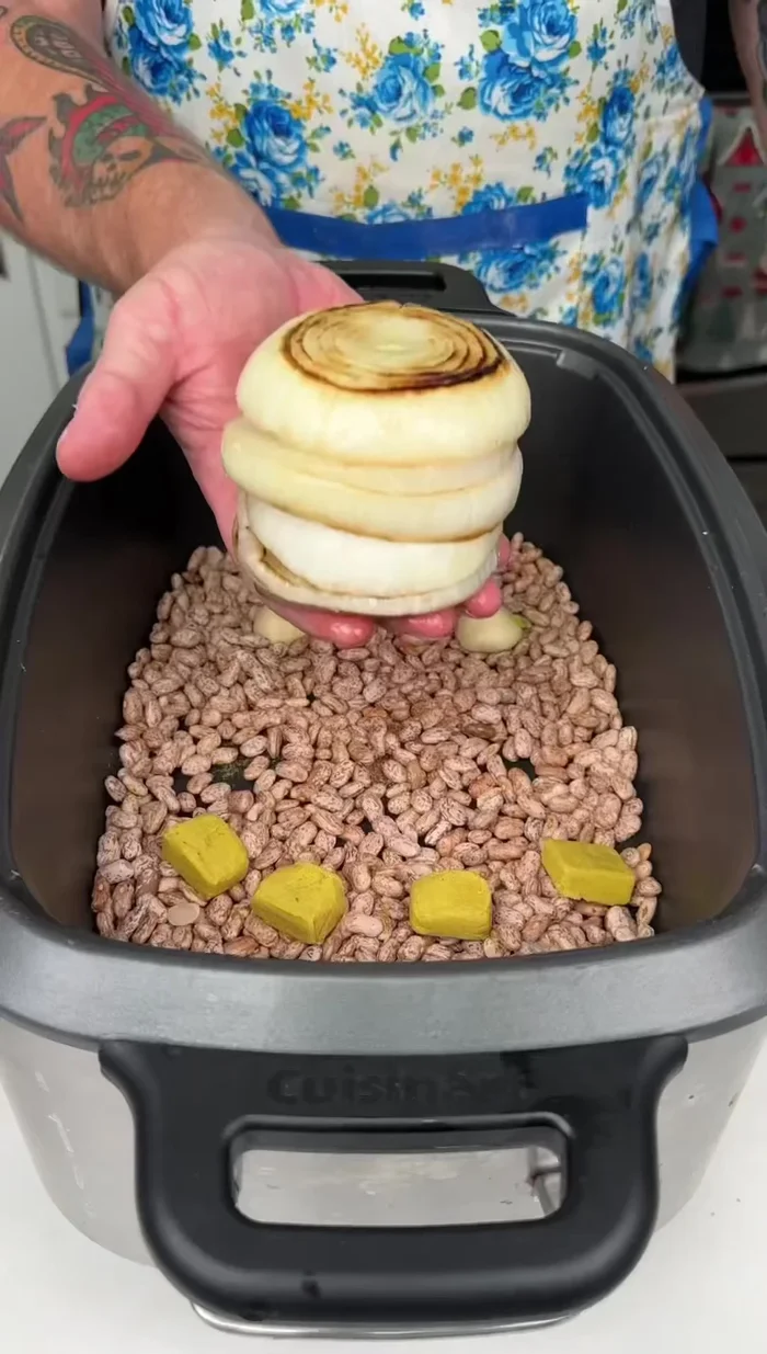 Add the caramelized onion to the slow cooker.