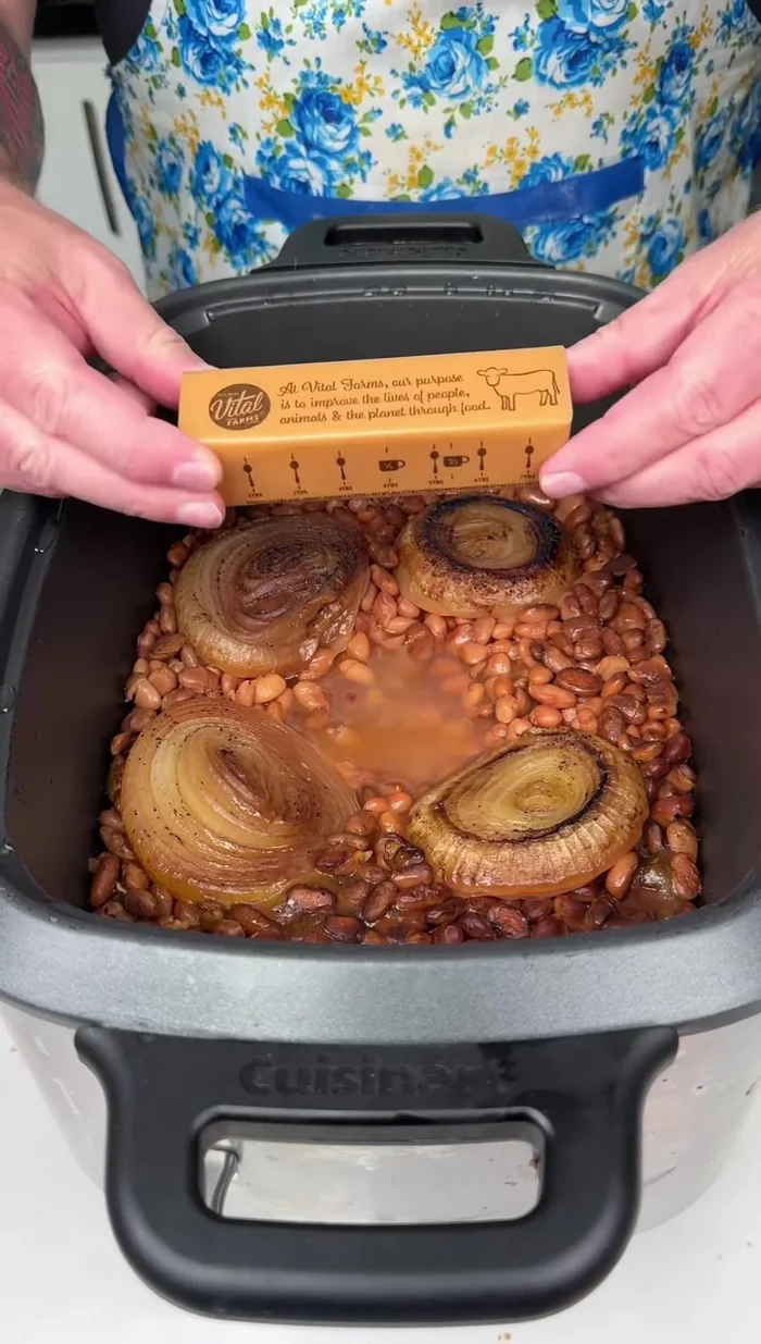 Add one stick of salted butter to the slow cooker.