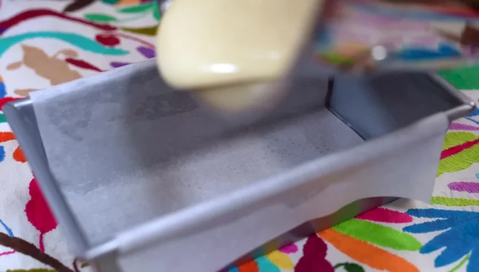 Pour batter into the prepared mold. Tap gently to remove air bubbles.