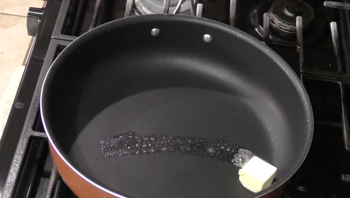 Heat butter and a little oil in a saucepan. Fry the chicken until browned on both sides.