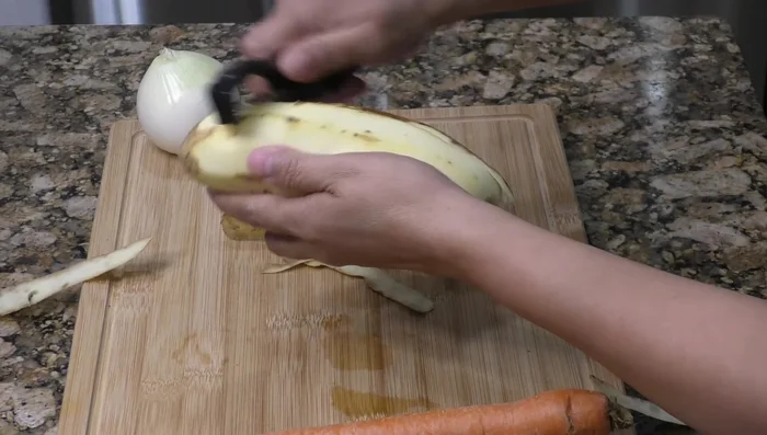Peel and cut the potato into desired shapes (sticks or squares). Submerge in water to prevent discoloration. Cut carrots into slices and onion.