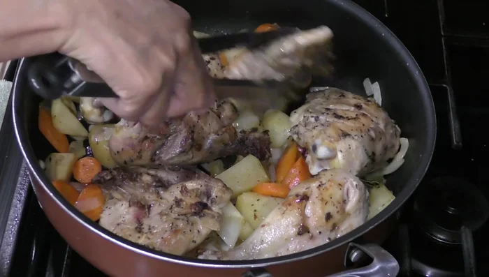 Return the chicken to the saucepan. Add the sauce and 2 cups of water. Season with salt and add serrano chilies.