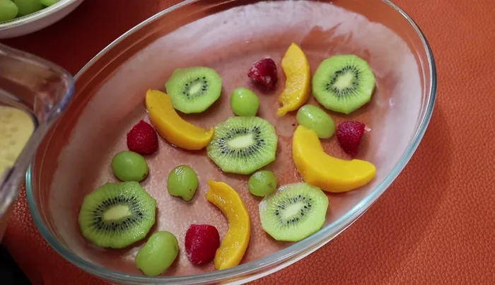 Pour the three-milk mixture over the fruits, covering them.