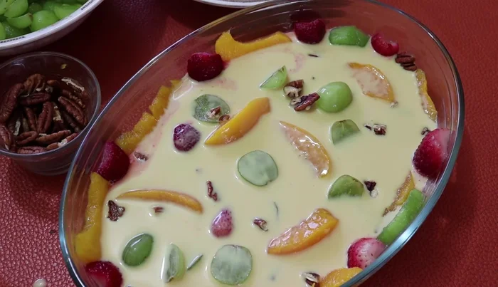 Repeat the layering process (fruit, mixture, refrigerate) until the dessert is almost completely set.