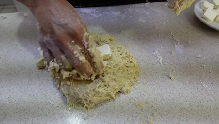 Gradually add 150g of softened butter, kneading until the dough is smooth and elastic (approximately 40 minutes).