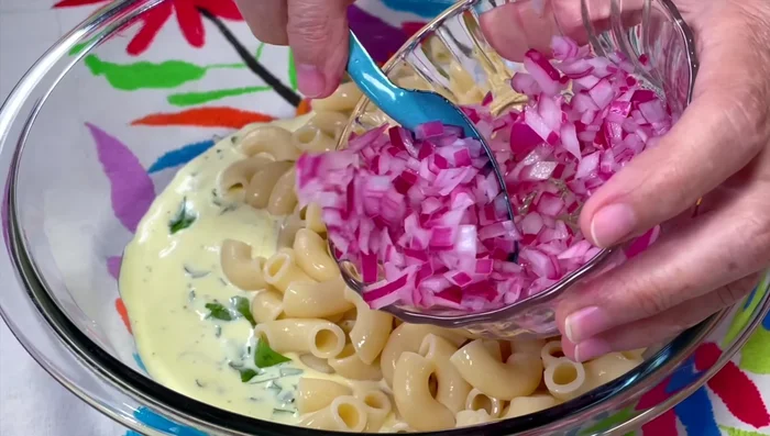 Combine cooked pasta, dressing, tuna, cucumber, onion, red pepper, celery, and cilantro.