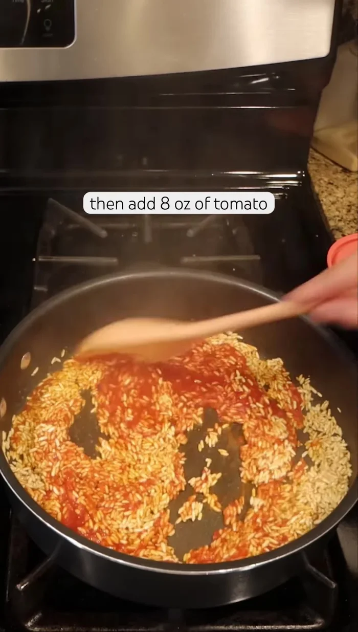 Add 8 oz of tomato sauce and stir until evenly coated.