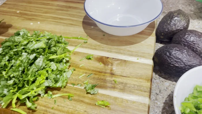 Prepare Salsa: Chop tomatoes, cilantro, avocados, onions, and limes. [250]