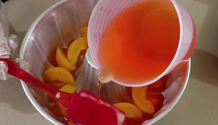 Add a thin layer of peach gelatin over the peaches to secure them.