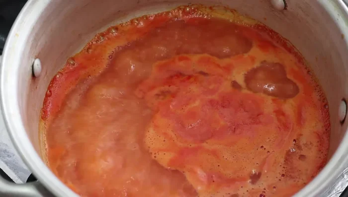 Bring the tomato sauce to a boil and season.