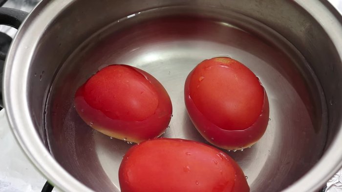 Place three tomatoes in a saucepan, cover with water, and bring to a boil until the consistency changes.